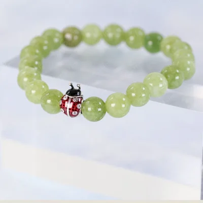 Ladybug bead charm green peridot beaded bracelet — product image 1